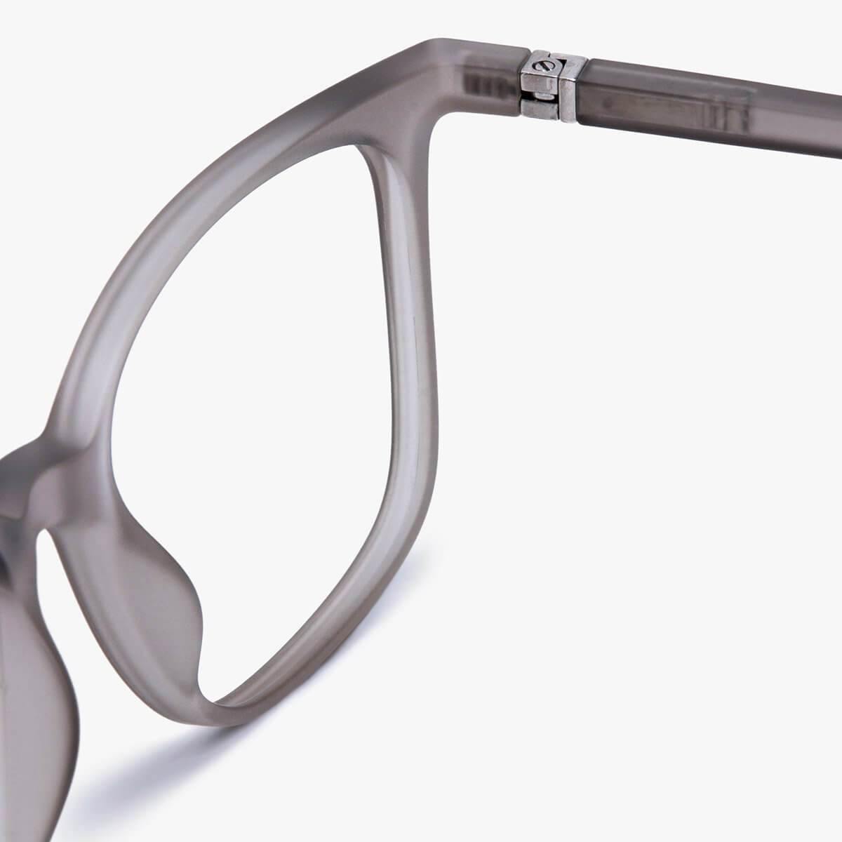 Grey eyeglasses frame close-up with metal hinge detail