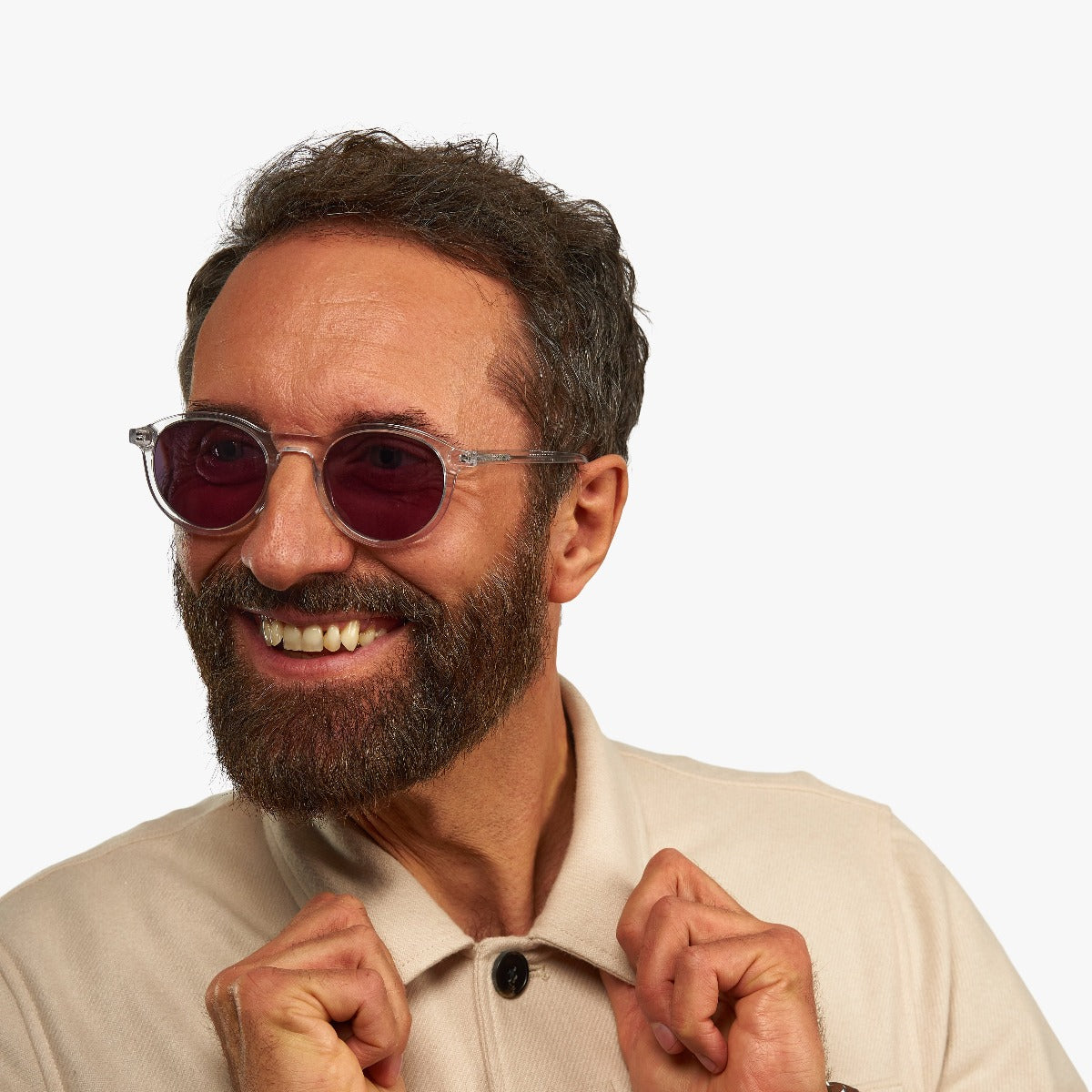 Person wearing round crystal white glasses with tinted lenses