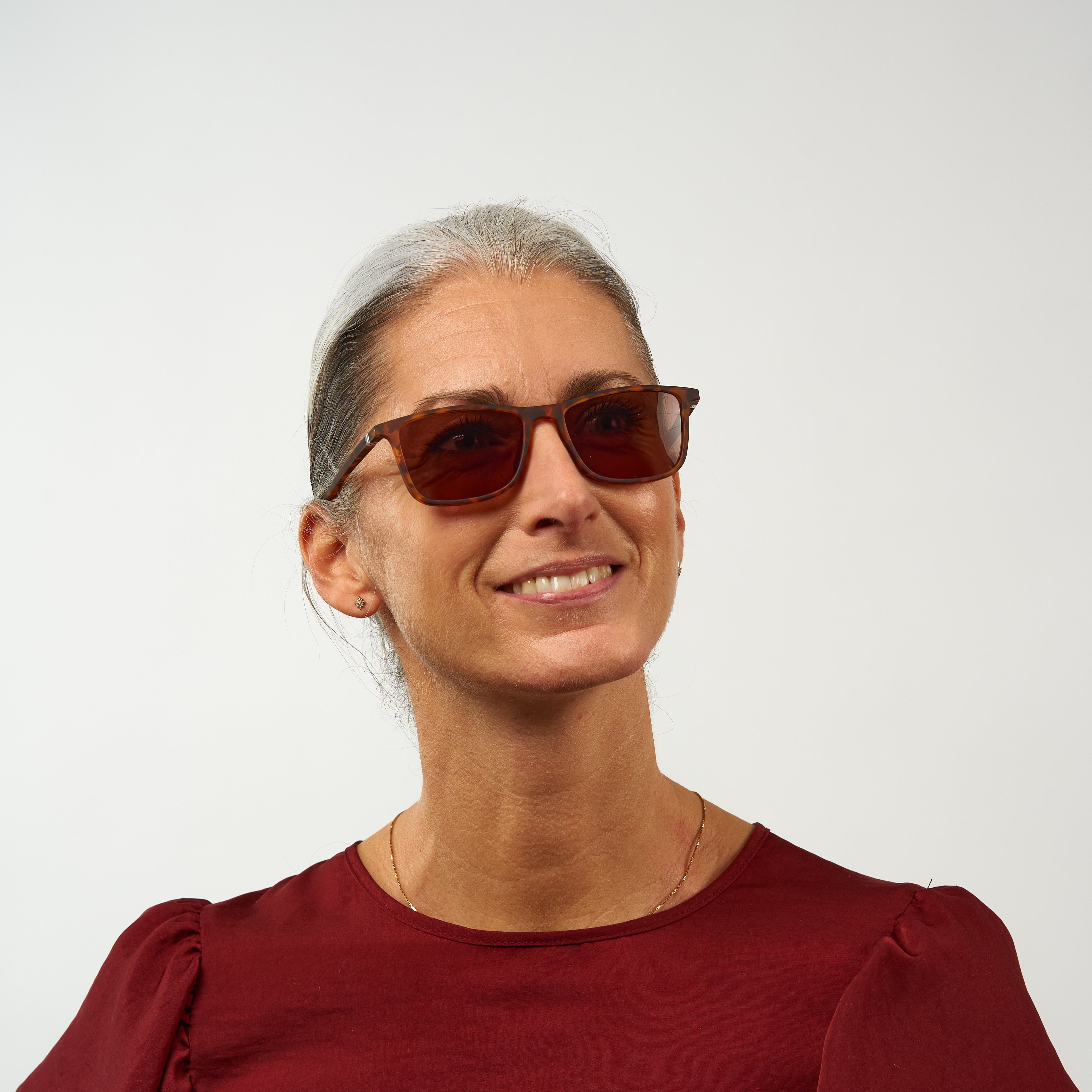 Person wearing Oslo Dark Turtle glasses with brown square frames